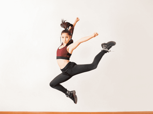 Jazz dancer leaping in the studio