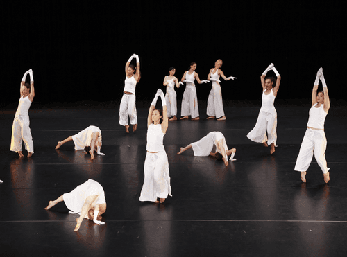 Lyrical dancers performing expressive movement on stage