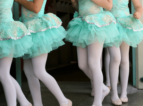 Young dancers wearing turquoise tutus