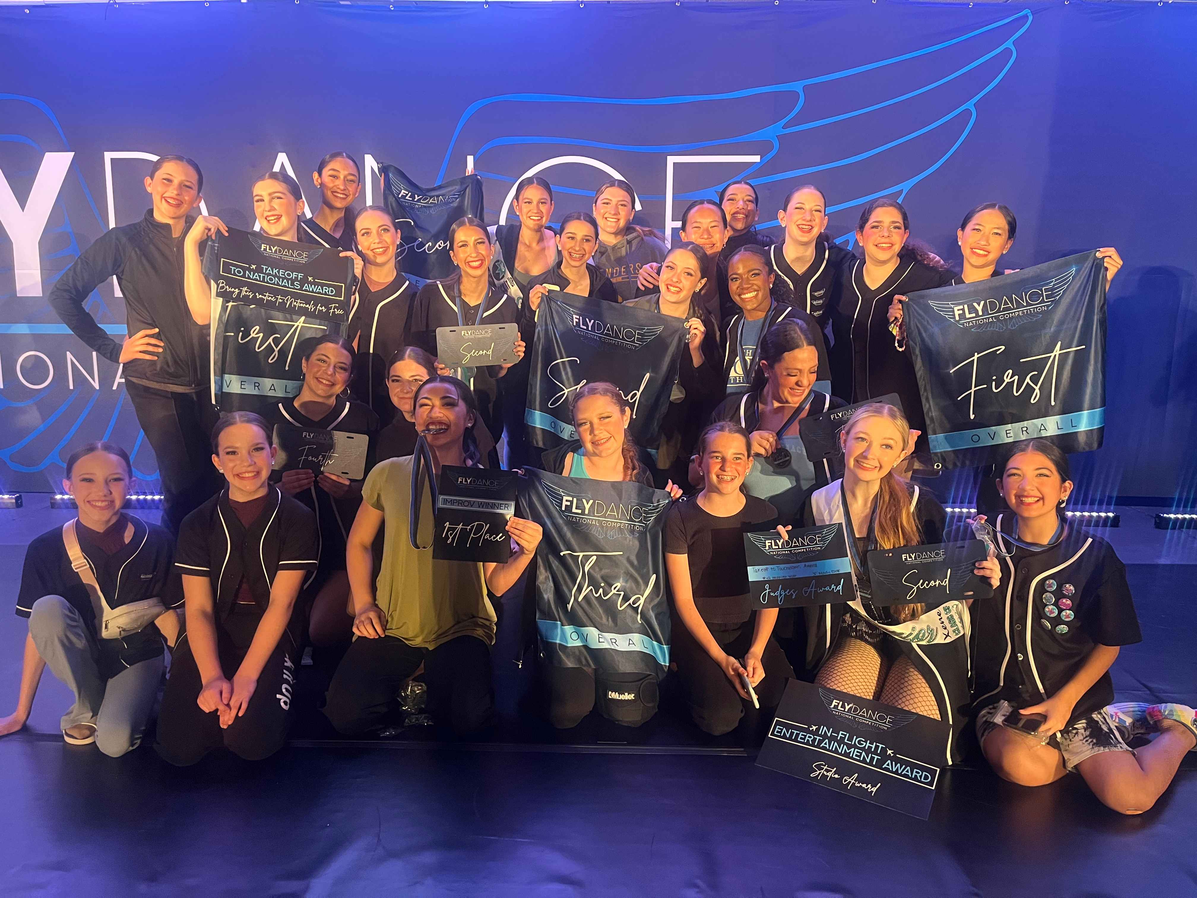 Kick It Up dance team celebrating competition awards